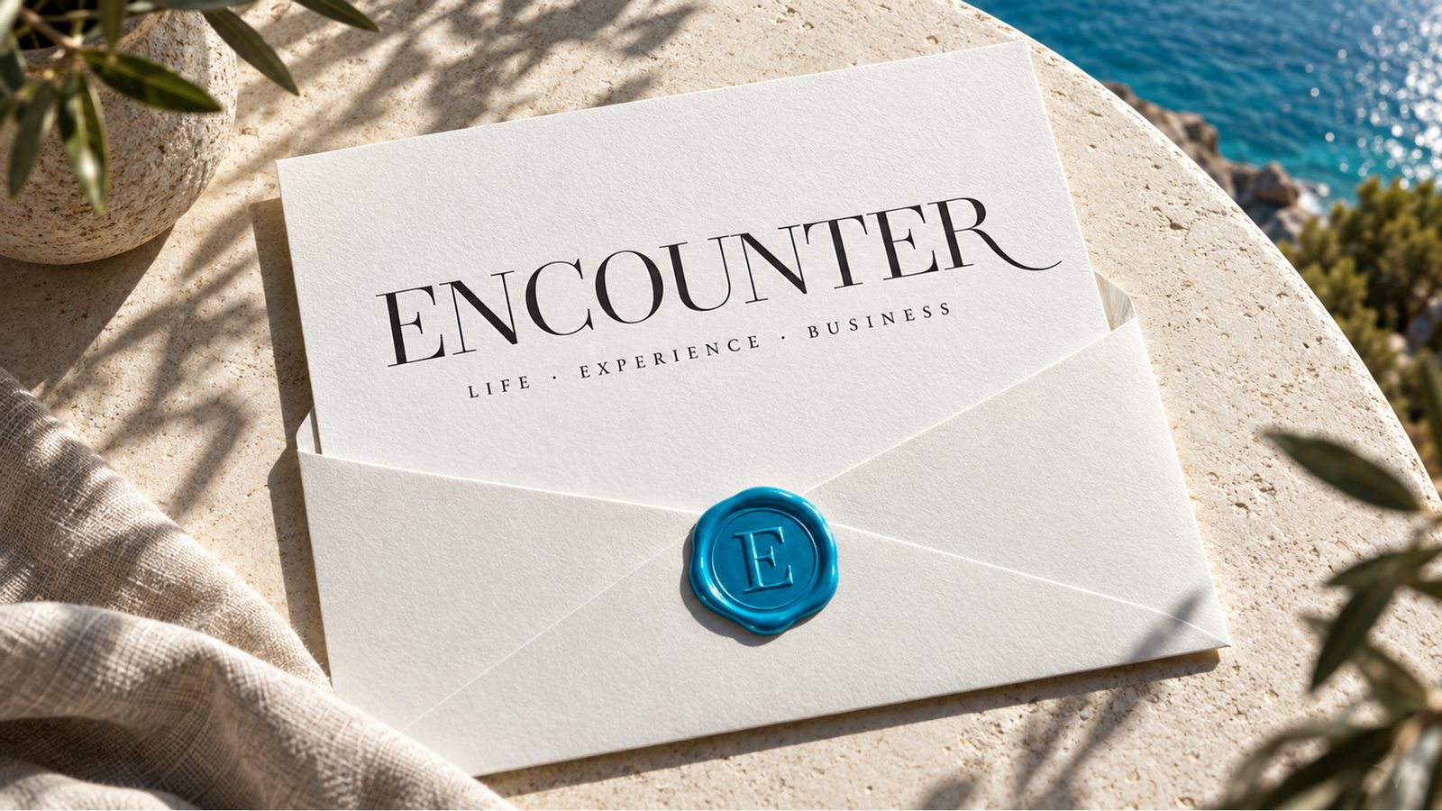 A sealed Encounter invitation on linen and stone